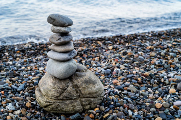 istock Stone tower of pebbles on sea shore 986384314