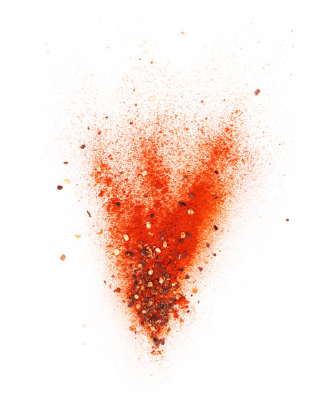 istock Red chili powder and chili flakes burst 986387230