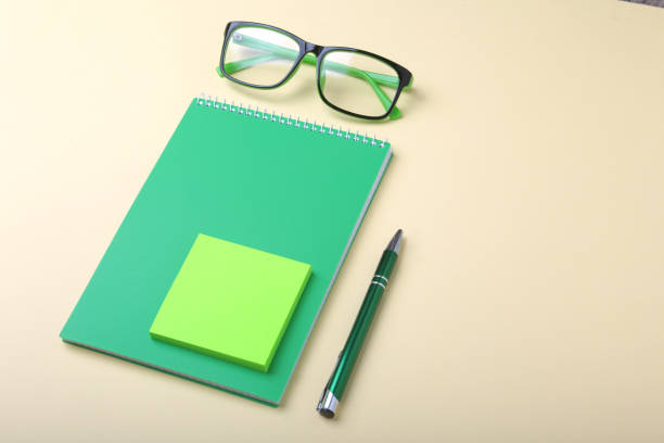 istock Business accessories on desktop: notebook, diary, fountain pen, glasses. Macro with blur and soft focus. 986426056