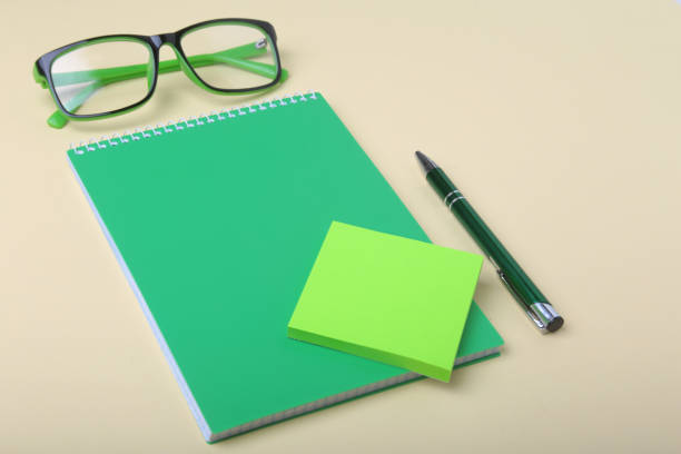 istock Business accessories on desktop: notebook, diary, fountain pen, glasses. Macro with blur and soft focus. 986426076