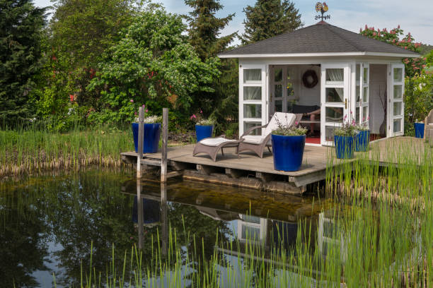 белый павильон и терраса возле пруда в саду - garden pavilion стоковые фото и изображения