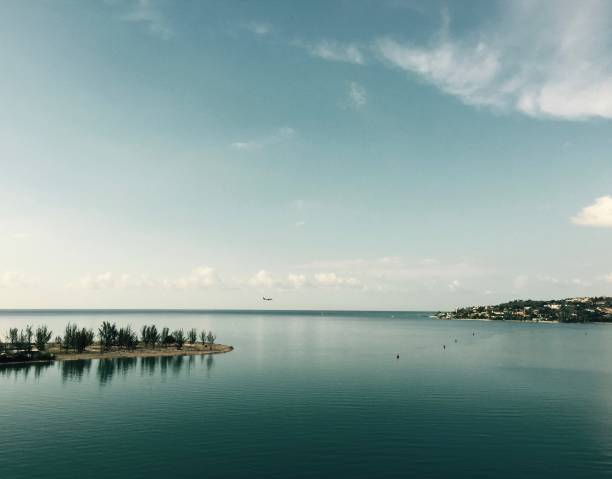 istock Little island and airplane on horizon 986449614