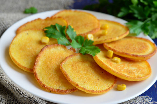 istock Homemade Corn fritters on the plate with parsley 986454730