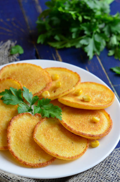 istock Homemade Corn fritters on the plate with parsley 986454804