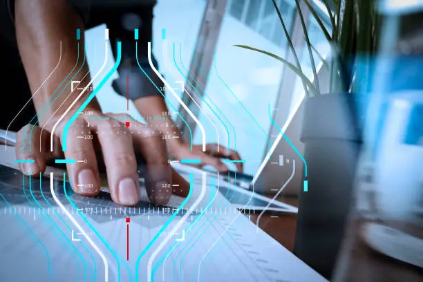 Business data analytics process management diagram.businessman hand working with new modern computer and business strategy documents with glass of water and greenplant foreground on wooden desk in office