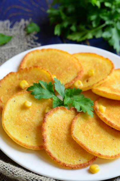istock Homemade Corn fritters on the plate with parsley 986454880