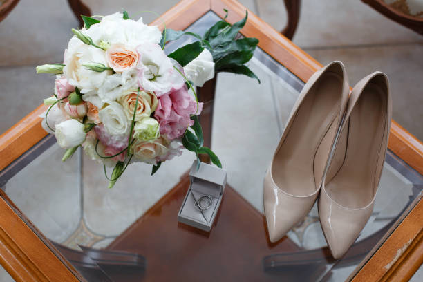 istock Wedding rings with a diamond, shoes and a wedding bouquet 986455420