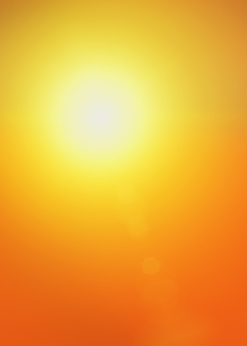 A dazzling golden sun shines against a background going from yellow to deep orange.