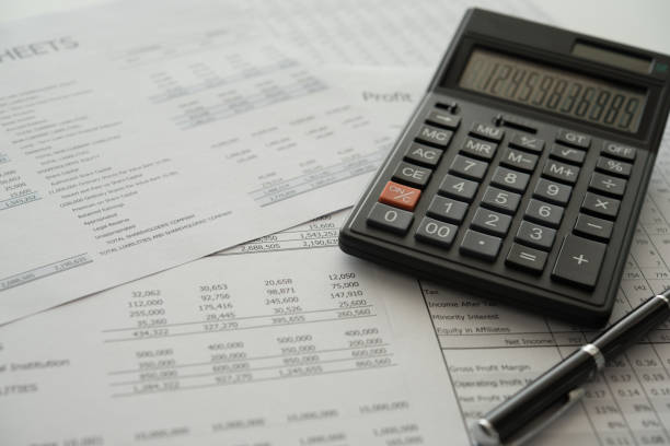 accounting audit bookkeeping accounting concept. calculator on financial statement and balance sheet annual. financial statement stock pictures, royalty-free photos & images
