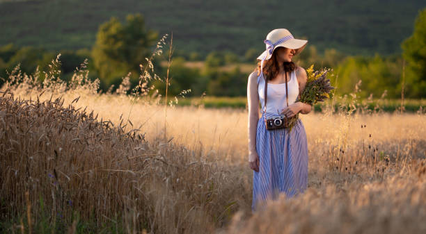 istock Thinkful woman walking in field of wheat 986465976