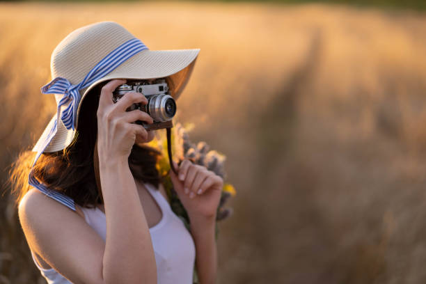 istock Woman photographing sunset 986466134