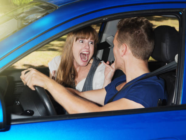 istock Young couple driving in car have big argument 986469816