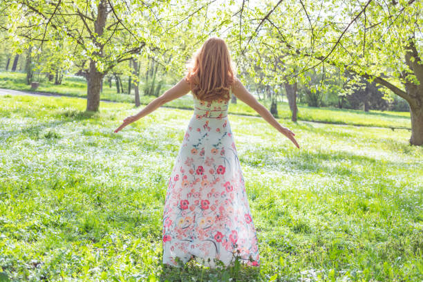 Joyful woman open armed on the meadow