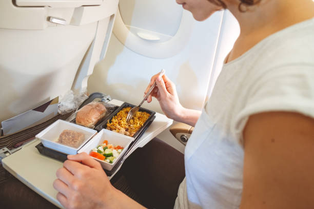istock Eating served meal on the plane 986471068