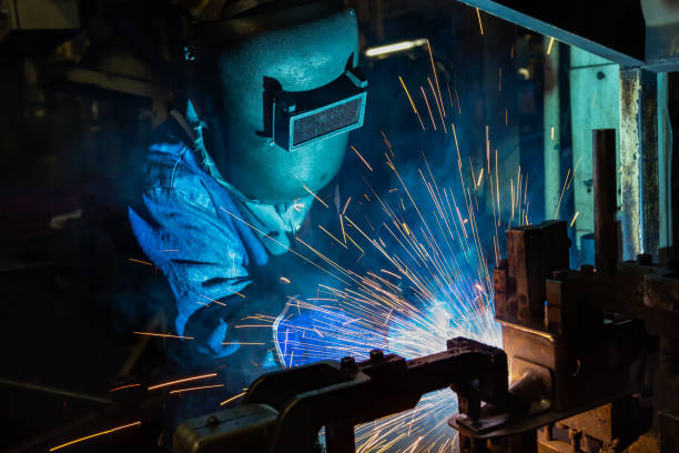 istock Welder is welding automotive part in production line 986471162
