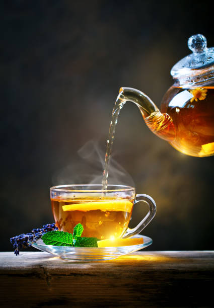 istock Process brewing tea,tea ceremony. Cup of freshly brewed black tea,warm soft light 986475316