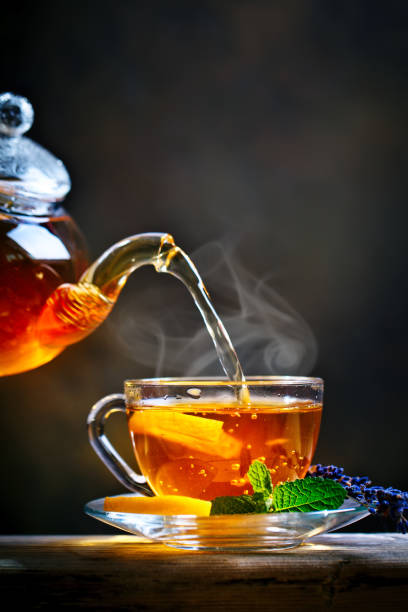 istock Process brewing tea,tea ceremony. Cup of freshly brewed black tea,warm soft light 986475356