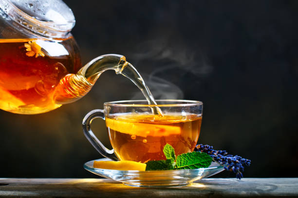 istock Process brewing tea,tea ceremony. Cup of freshly brewed black tea,warm soft light 986475414