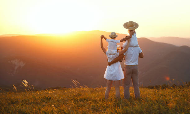 istock Happy family: mother, father, children son and daughter on sunset 986476180