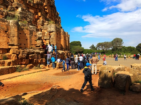 Tipaza, Algeria - May 7, 2016: People are just getting in and out from a small slit between bricks of Royal Mausoleum of Mauretania.