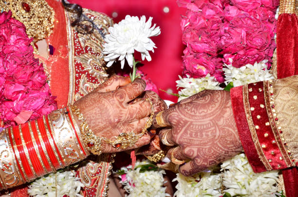istock Groom gives flower to bride 986479624