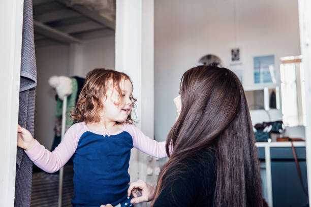istock Cute Toddler playing with her mother while getting ready for a day out 986479654