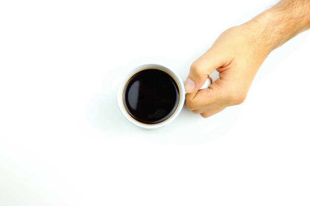 istock Coffe in hand on the clear, white background 986481782