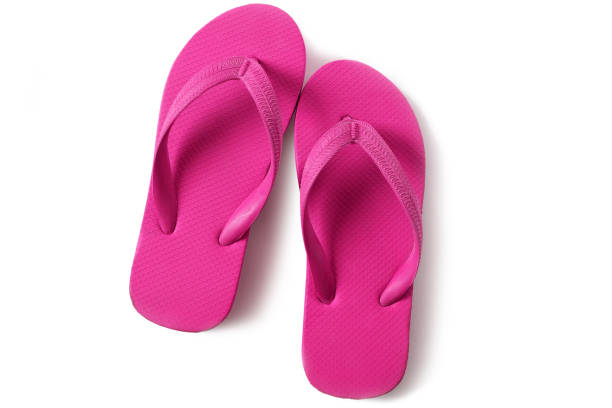 istock Pink flip flop sandals isolated on white background 986485832