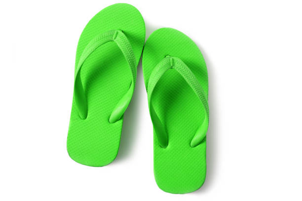 istock Green flip flop sandals isolated on white background 986486060