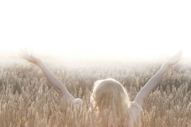 istock woman taking a deep breath in the  nature 986490374