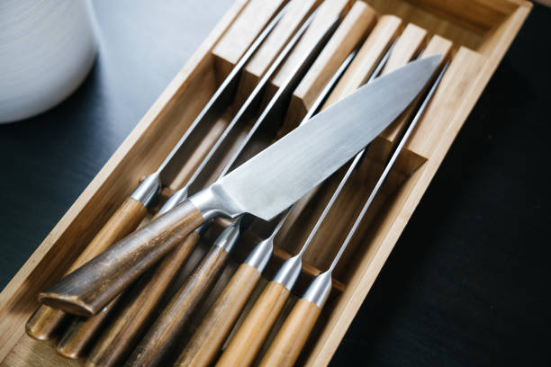 istock Steel kitchen knife with a wooden handle in the set. Kitchen tools to work together. 986504680