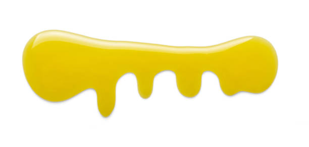 istock Flowing puddle of liquid sweet honey isolated on white 986510200
