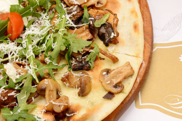 istock Pizza with bacon, mushrooms and arugula 986510330