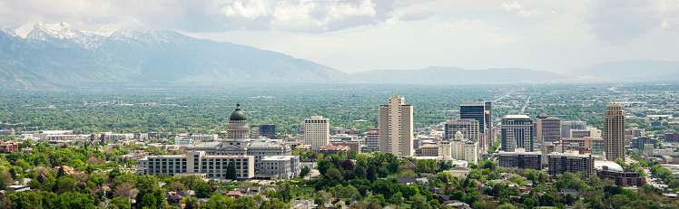 A high angle view over Salt Lake City, Utah's State Capital, with snow on the Rocky Moutains to the left.