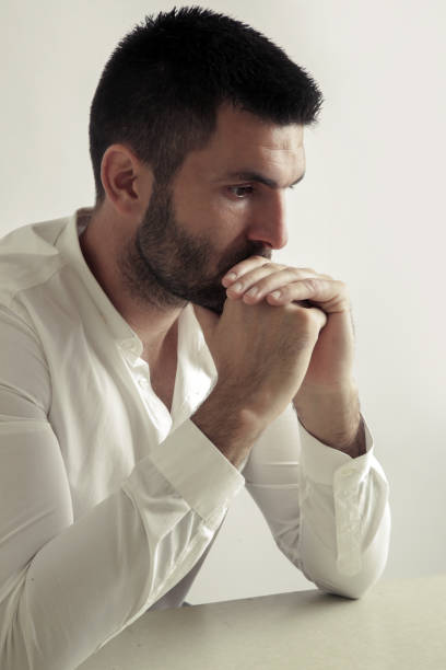istock Studio portrtait of young bearded man lost in deep thoughts 986514402