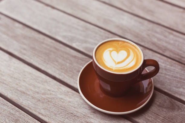 istock Cappuccino with the heart shape latte-art on wood background 986514634