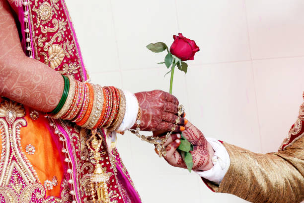 istock Groom gives Rose flower to bride 986518216