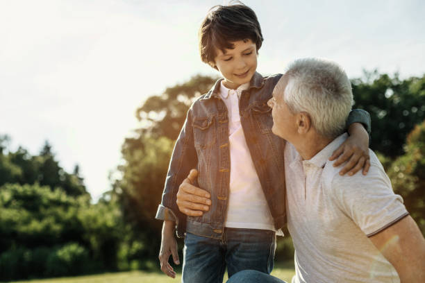 istock Boy and grandpa hugging and looking at each other 986519784