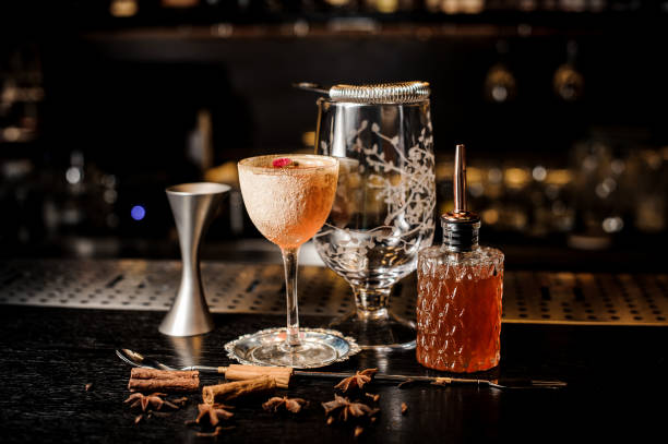 istock Fresh orange cocktail with rose petal on the holder and different bartender equipment 986524294