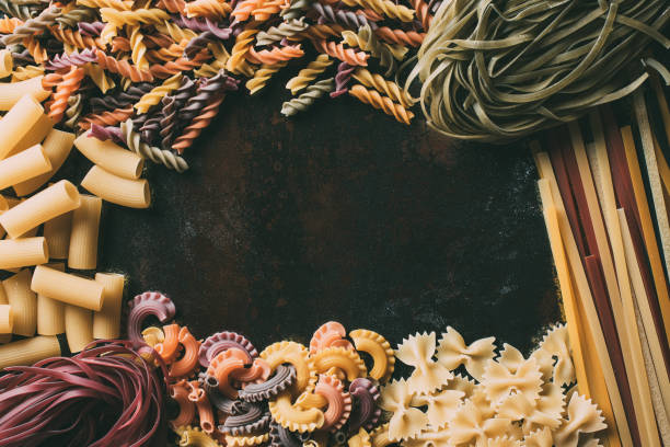 top view of various types of pasta on rustic metal table