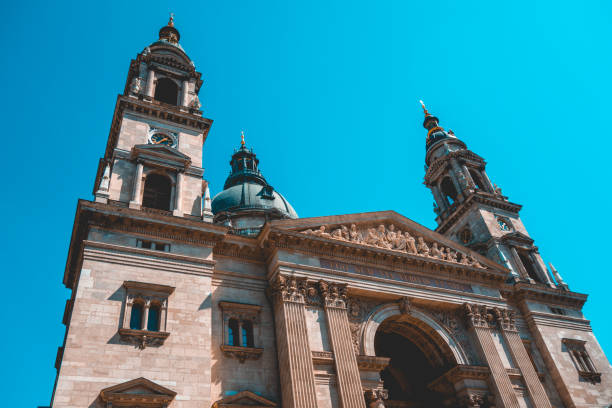istock low angle view of St. Stephen's Basilica at budapest with the frontside facade and entrance 986529564