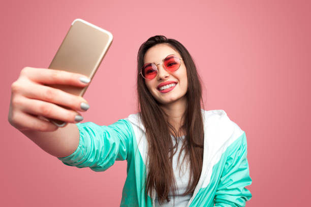 istock Stylish hipster woman taking selfie 986530730