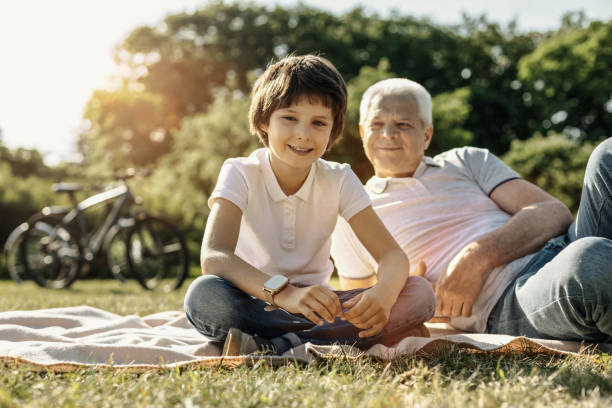 istock Smiling boy relaxing with his grandpa 986535522