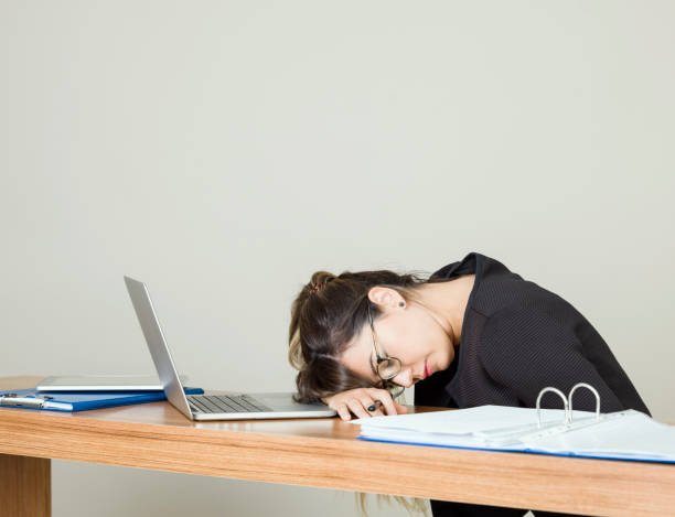 istock Tired businesswoman working with a laptop 986536120