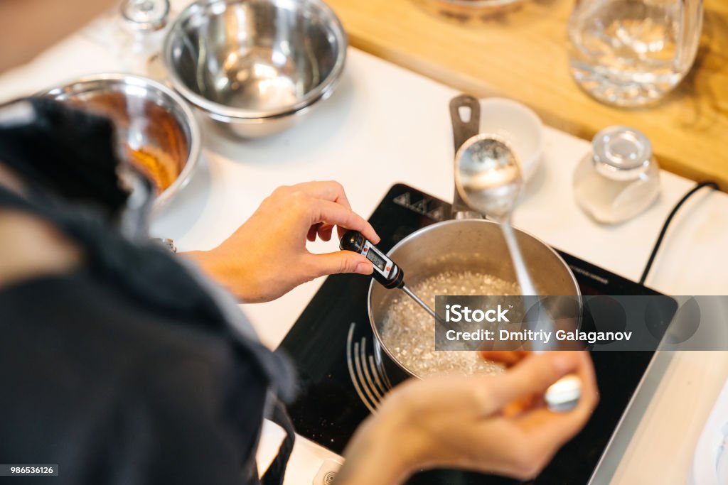 https://media.istockphoto.com/id/986536126/photo/the-cook-monitors-the-temperature-of-the-liquid-in-a-saucepan-on-a-stove-using-a-special.jpg?s=1024x1024&w=is&k=20&c=PM71EjZUF8MklC16laexdiA36qWzwfYRCPsd5oB0rMw=