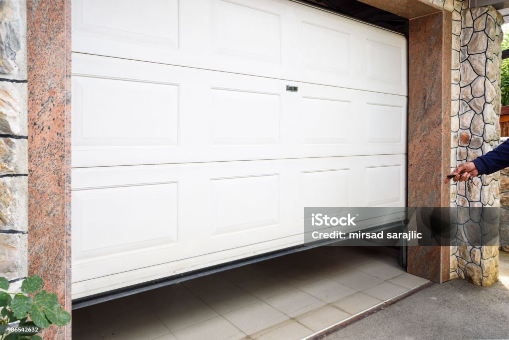 Garage door PVC Hand use remote controller for closing and opening garage door Garage Stock Photo