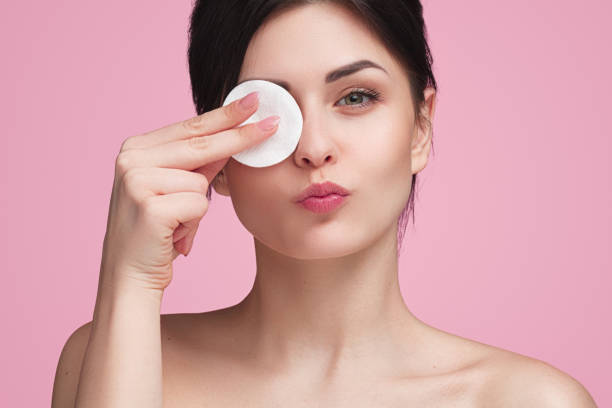 istock Beautiful woman with cotton pad in studio 986551560
