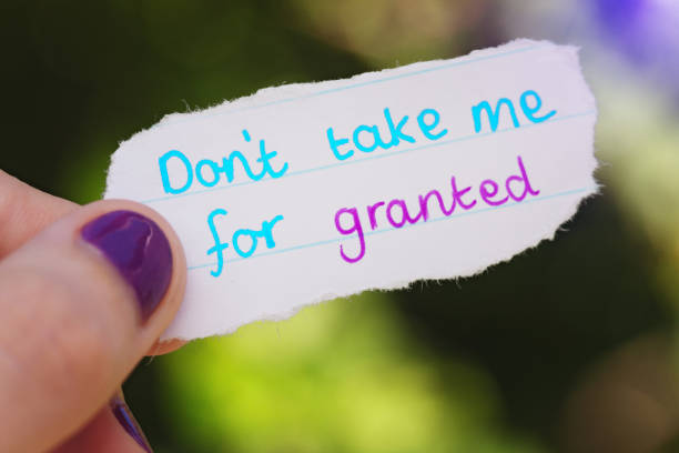 istock Female hand holds note: Don't take me for granted 986556246