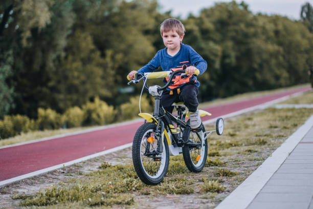 istock Small boy cycling and enjoying a day outdoors. 986560732