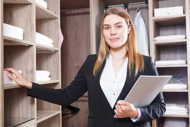 Photo of Saleswoman offering furniture for dressing room